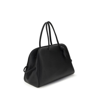 This large Travel Bowling Handbag by Jacquemus for women in bos taurus calf grained leather and black & signature presents a sculptural silhouette featuring a secure zipper, ample , and versatile for a sculptural finish.