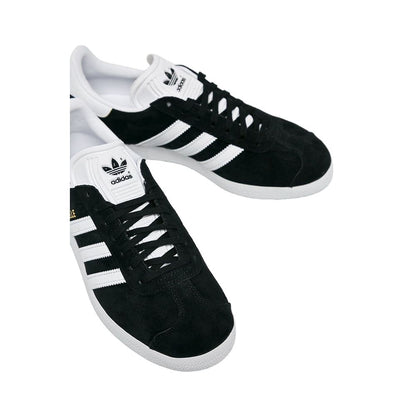 Sneakers by Adidas Originals for women in leather & rubber black features an sumptuous silhouette, showcasing the premium Women's Low-Top Casual Leather & Rubber Sneakers in a sumptuous low-top casual style that offers a sumptuous finish for refined style.