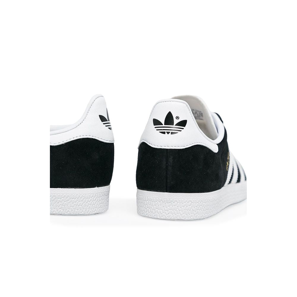 Sneakers by Adidas Originals for women in leather & rubber black presents a sumptuous silhouette as Women's Low-Top Casual Leather & Rubber Sneakers, expertly defined by a sumptuous low-top casual style for a sumptuous, high-fashion look.