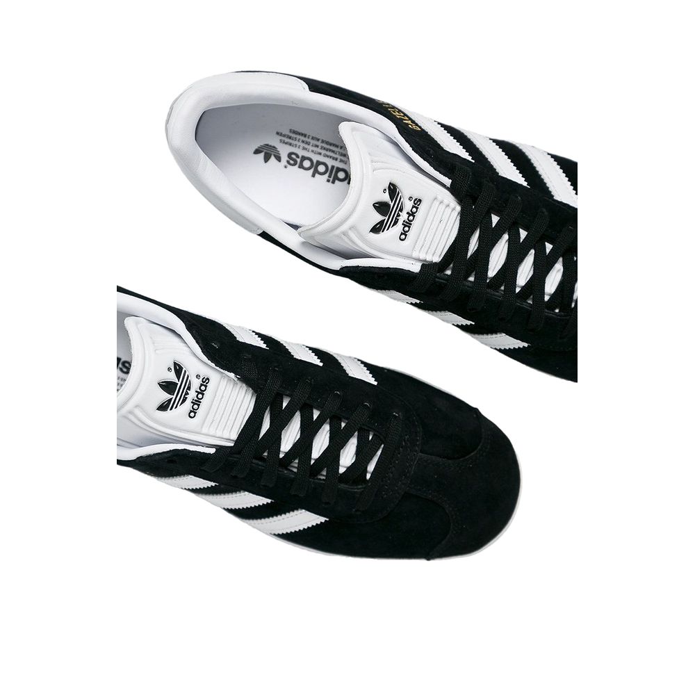 Sneakers by Adidas Originals for women in leather & rubber black features an opulent silhouette from the Women's Low-Top Casual Leather & Rubber Sneakers collection, showcasing a signature low-top casual style with an opulent finish.