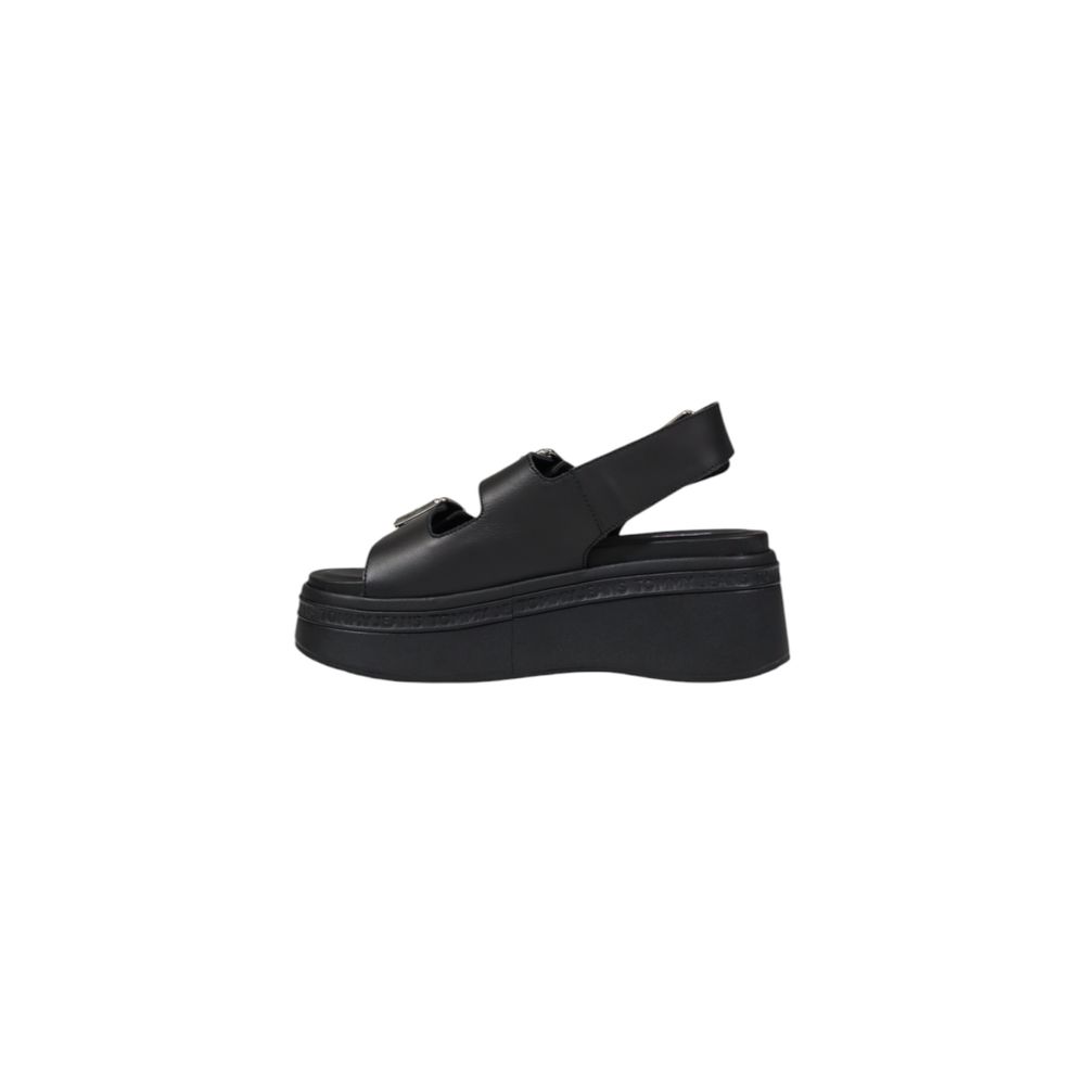 Wedge Sandals by Tommy Hilfiger Jeans for women in leather and black presents a sculptural silhouette, showcasing the signature style of the Women's Leather Wedge Sandals with a sculptural wedge and sculptural .