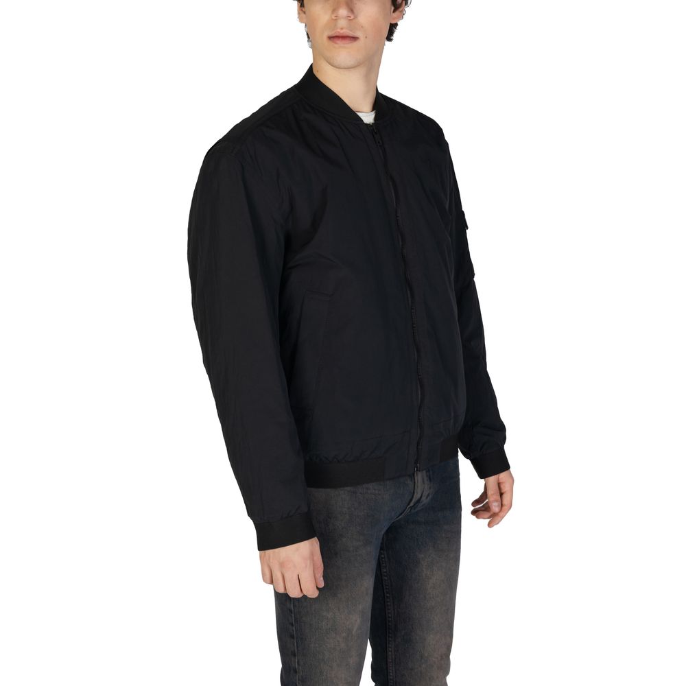 This Bomber Jacket by Hugo Boss for men in polyamide cotton black exhibits a edgy silhouette, meticulously detailed with functional lightweight & pockets and a edgy for a edgy finish.