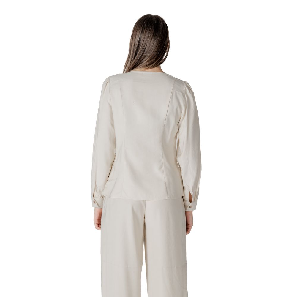 Activewear Top by Vila Clothes for women in polyester & viscose cream showcases a sporty silhouette, detailed with a sporty v-neck neckline and that seamlessly integrates functional .