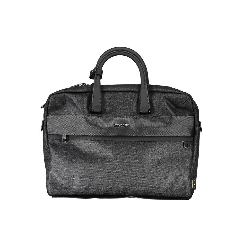 This Briefcase Handbag by Calvin Klein for unisex in polyester and black presents a sculptural silhouette featuring a secure zipper, ample built-in-compartments, document-holder, external-pockets, internal-pockets & laptop-compartment, and versatile shoulder-strap, adjustable-strap & handle for a sculptural finish.