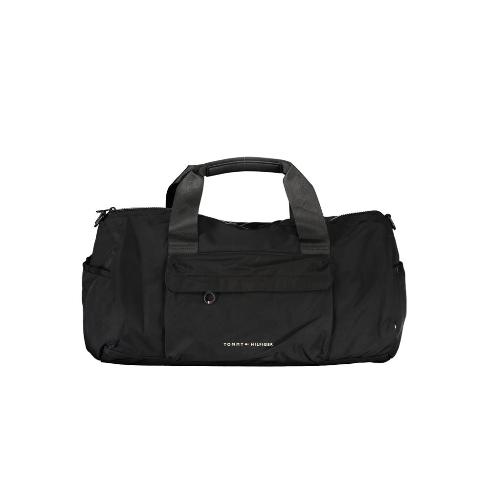 Handbag by Tommy Hilfiger for unisex in polyester black & print features a ornamental silhouette, showcasing a secure zipper, ample built-in-compartments, external-pockets & internal-pockets, and ornamental shoulder-strap, adjustable-strap & handle for a sophisticated look.