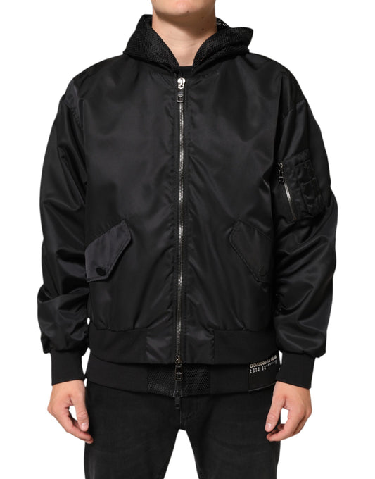 Hooded Bomber Jacket by Dolce & Gabbana for men in nylon & polyester black showcases a bohemian silhouette, artfully detailed with a bohemian hooded neckline and signature pockets & hooded for a truly bohemian finish.