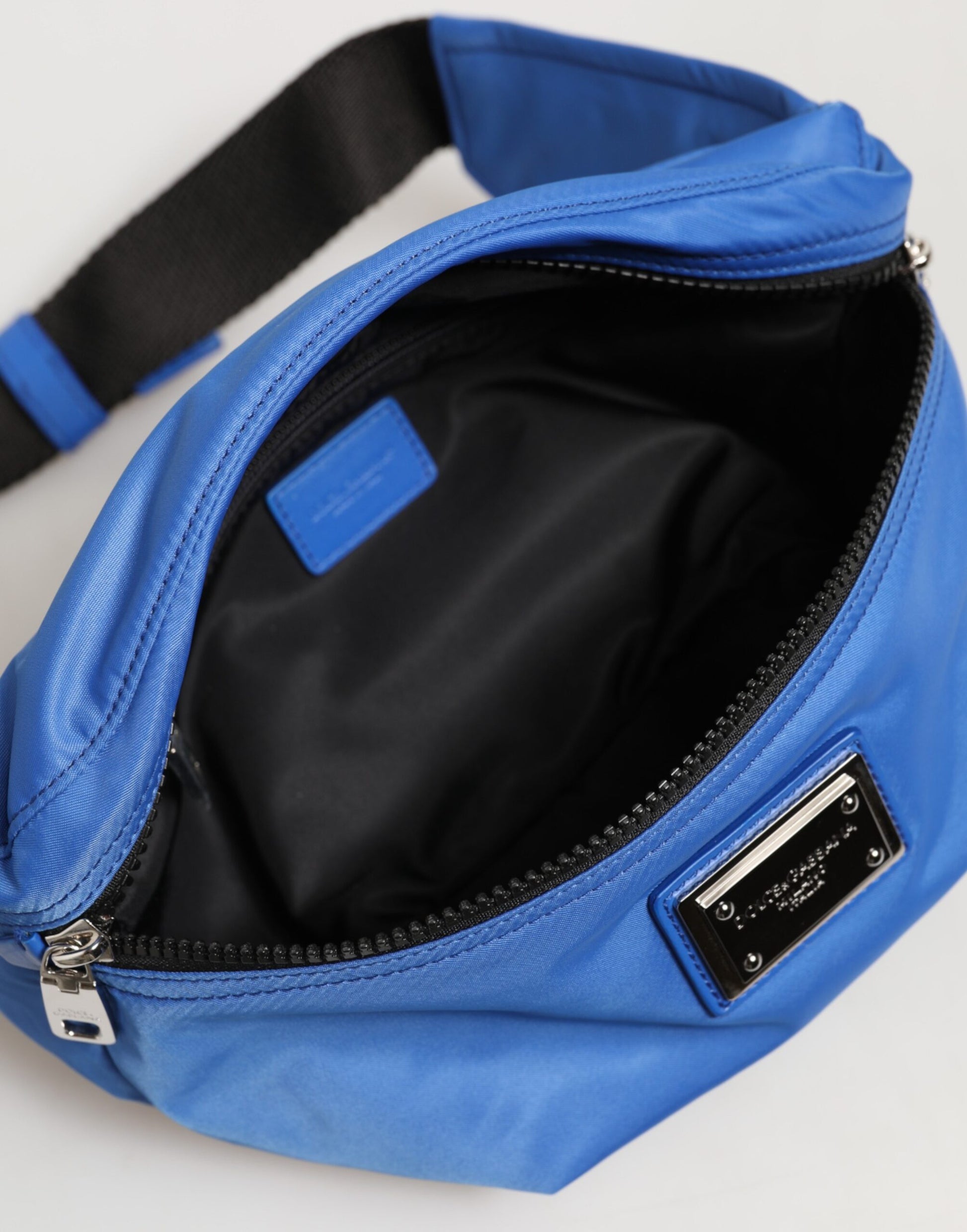 Fanny Pack Belt Bag by Dolce & Gabbana for men in calf leather & polyamide blue features a jet-setting Calf Leather Polyamide Fanny Pack Belt Bag design with a secure zipper, jet-setting built-in-compartments, and versatile adjustable-strap & belt-strap for a jet-setting look.