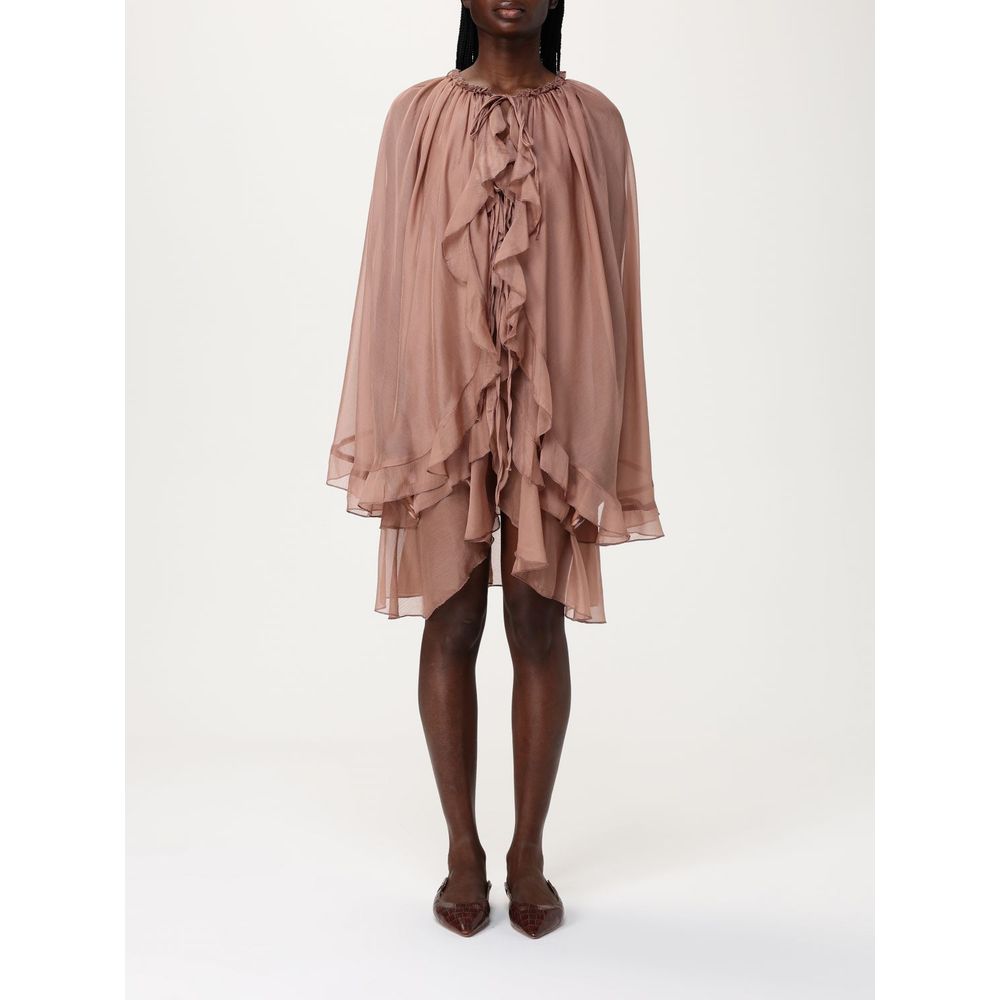 Dress by Tpn for women in silk beige features an magnificent silhouette, artfully detailed with a magnificent and sleeveless that flows into an magnificent midi.