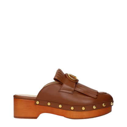 Clogs Slippers by Valentino Garavani for women in leather brown presents a effortless silhouette, showcasing the elegant Women's Leather Clogs Slippers design with its unique and sophisticated .