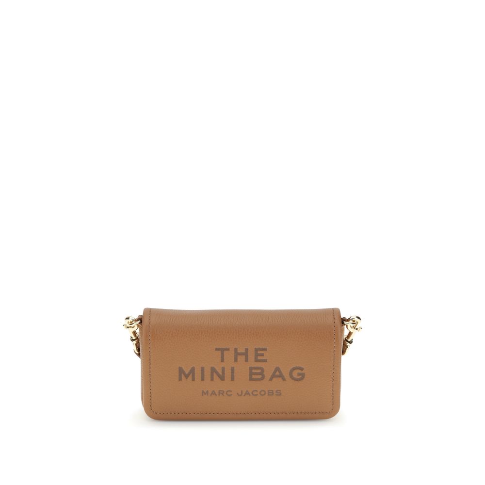 Mini Shoulder Flap Bag by Marc Jacobs for women in bos taurus calf grained leather brown, signature & monogram features an effortlessly chic silhouette with a secure flap, magnetic & button, ample single-compartment, and versatile shoulder-strap & adjustable-strap for effortlessly chic everyday luxury.