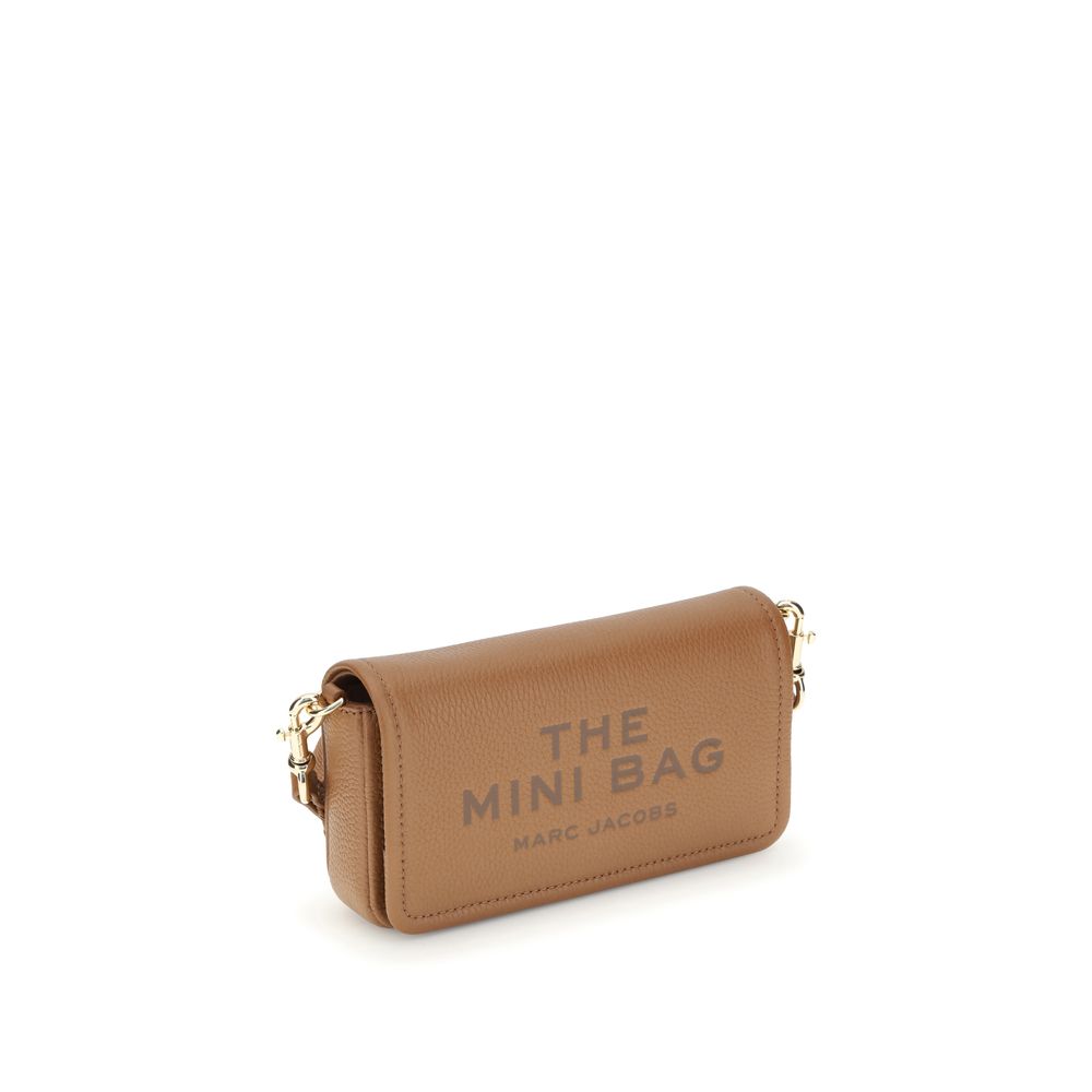 Mini Shoulder Flap Bag by Marc Jacobs for women in bos taurus calf grained leather brown, signature & monogram showcases a enviable silhouette, artfully detailed with a secure flap, magnetic & button, organized single-compartment, and versatile shoulder-strap & adjustable-strap for a enviable look.