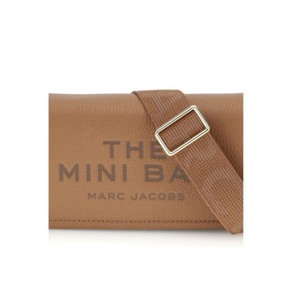 Mini Shoulder Flap Bag by Marc Jacobs for women in bos taurus calf grained leather brown, signature & monogram features a distinguished silhouette, showcasing a secure flap, magnetic & button and distinguished single-compartment with versatile shoulder-strap & adjustable-strap for a distinguished finish.