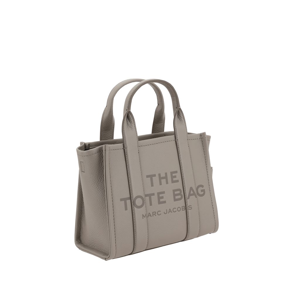 Small Tote Handbag by Marc Jacobs for women in bos taurus calf grained leather gray & monogram features a contemporary silhouette, showcasing a secure , ample , and contemporary shoulder-strap, handle & adjustable-strap for a sophisticated look.