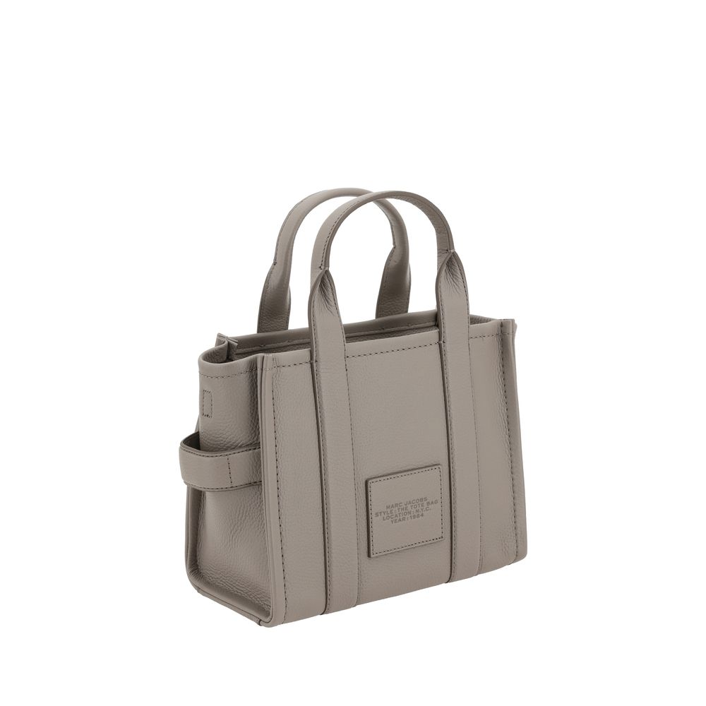 Small Tote Handbag by Marc Jacobs for women in bos taurus calf grained leather gray & monogram features a signature silhouette, showcasing a secure and signature with versatile shoulder-strap, handle & adjustable-strap for a sophisticated look.