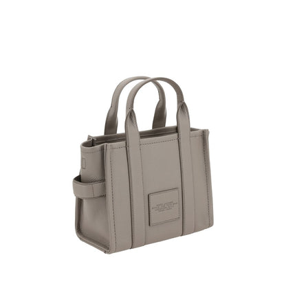 Small Tote Handbag by Marc Jacobs for women in bos taurus calf grained leather gray & monogram features a signature silhouette, showcasing a secure and signature with versatile shoulder-strap, handle & adjustable-strap for a sophisticated look.