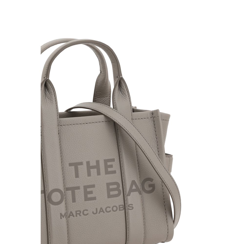 Small Tote Handbag by Marc Jacobs for women in bos taurus calf grained leather gray & monogram presents a ornamental silhouette, showcasing a secure , ample , and versatile shoulder-strap, handle & adjustable-strap for a ornamental finish.