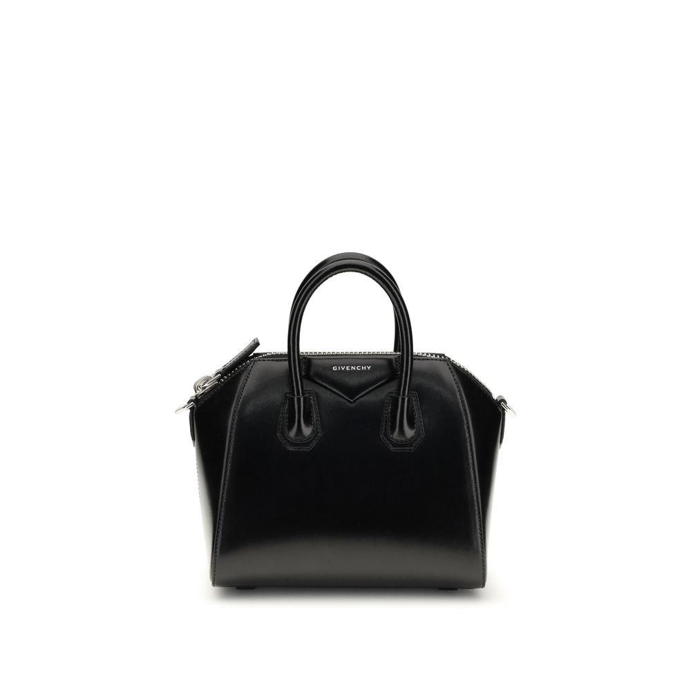 This Compact Evening Box Clutch Handbag by Givenchy for women in bos taurus calfskin leather and black, silver & signature presents a sculptural silhouette featuring a secure , ample , and versatile shoulder-strap, handle & adjustable-strap for a sculptural finish.