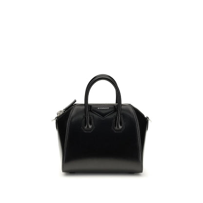This Compact Evening Box Clutch Handbag by Givenchy for women in bos taurus calfskin leather and black, silver & signature presents a sculptural silhouette featuring a secure , ample , and versatile shoulder-strap, handle & adjustable-strap for a sculptural finish.