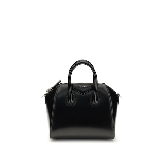 This Compact Evening Box Clutch Handbag by Givenchy for women in bos taurus calfskin leather and black, silver & signature presents a sculptural silhouette featuring a secure , ample , and versatile shoulder-strap, handle & adjustable-strap for a sculptural finish.