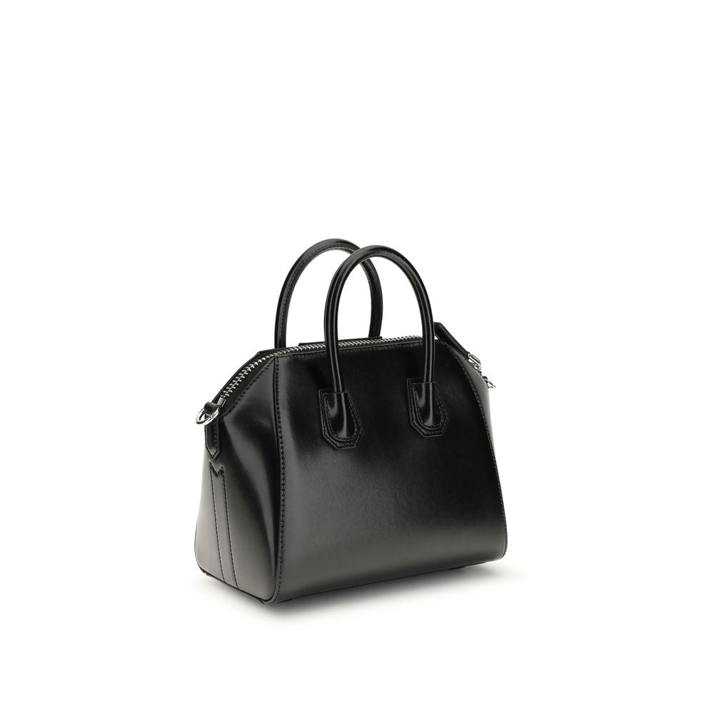 Compact Evening Box Clutch Handbag by Givenchy for women in bos taurus calfskin leather black, silver & signature features a contemporary silhouette, showcasing a secure , ample , and contemporary shoulder-strap, handle & adjustable-strap for a sophisticated look.