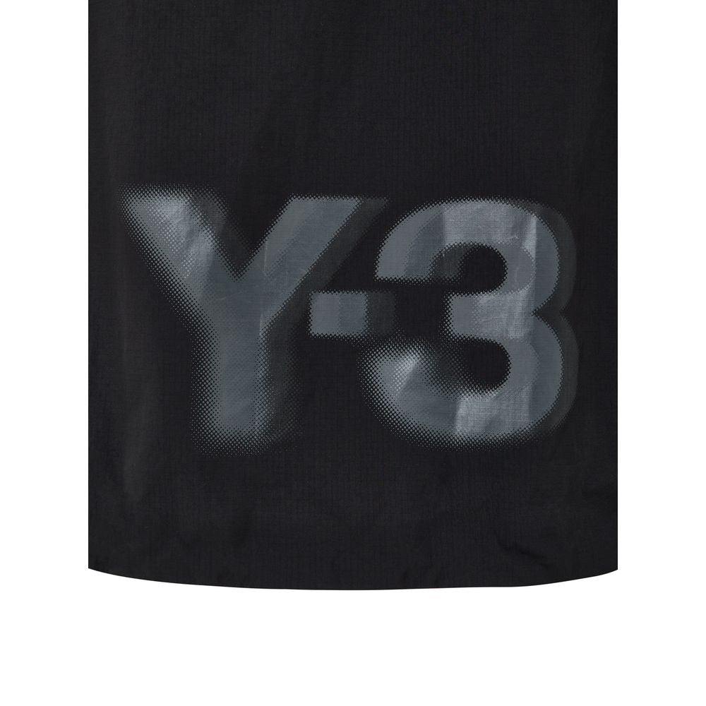 Hooded Windbreaker Jacket by Y-3 for women in polyamide black features an perennial silhouette with a refined hooded neckline and perennial lightweight, pockets, hooded & windproof for a sophisticated weather-resistant look.