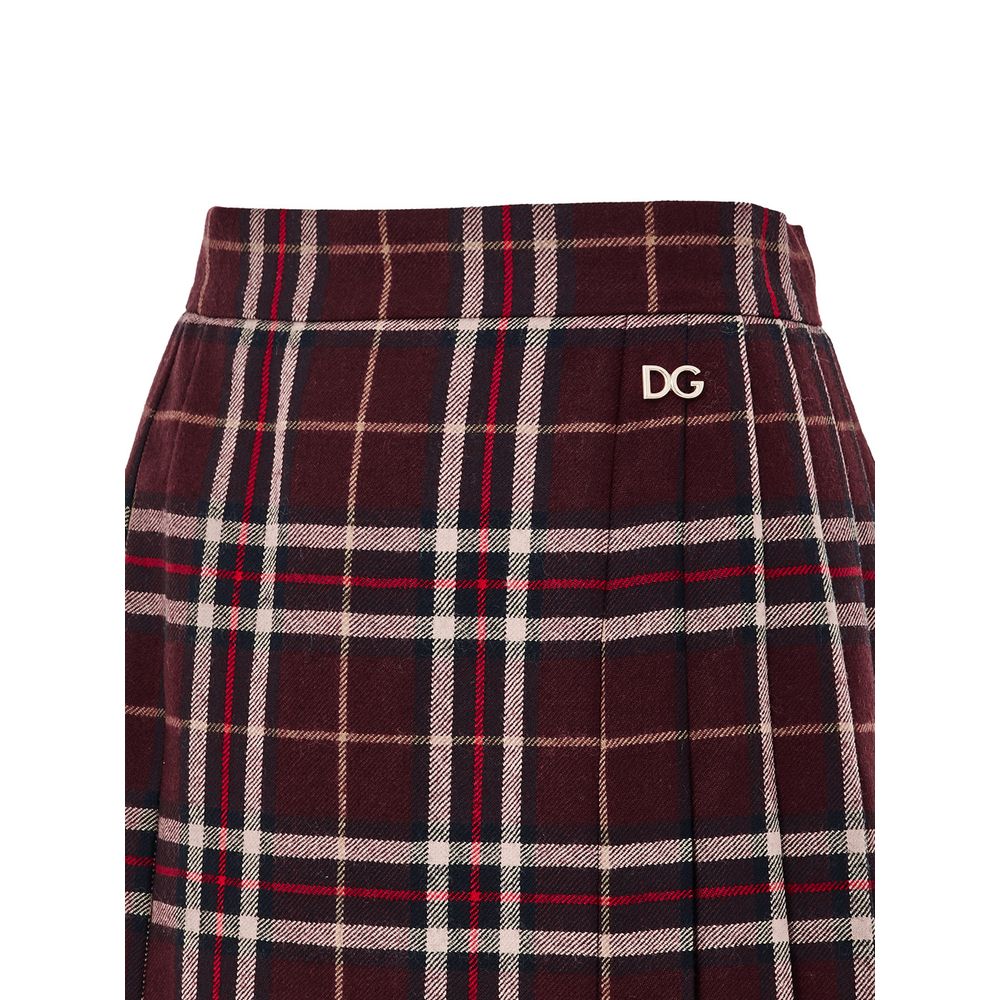 Skirt by Dolce & Gabbana for women in wool bordeaux, burgundy, gold & tartan features an relaxed-yet-refined silhouette that elegantly showcases the Women's Pleated Wool Skirt design and sophisticated mini.