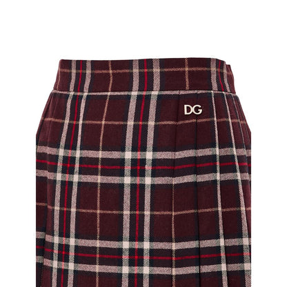 Skirt by Dolce & Gabbana for women in wool bordeaux, burgundy, gold & tartan features an relaxed-yet-refined silhouette that elegantly showcases the Women's Pleated Wool Skirt design and sophisticated mini.