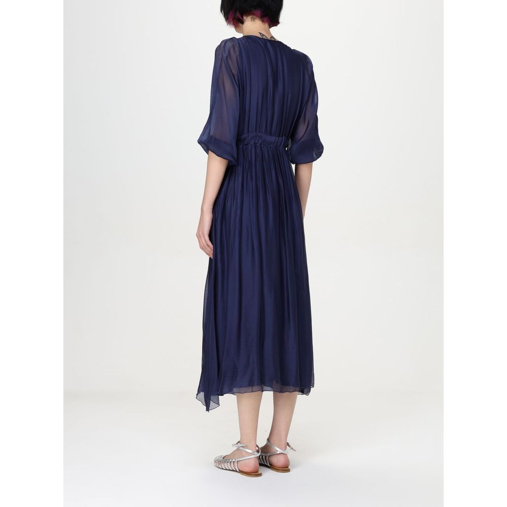 Dress by Kaos for women in silk green features a dramatic silhouette, showcasing an elegant and that flows into a dramatic midi short.