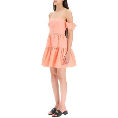 Dress by Staud for women in orange features a dramatic silhouette, showcasing an elegant and that flows into a dramatic short mini.