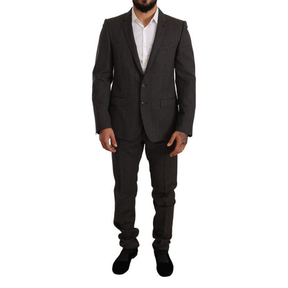 This Pant Suit by Dolce & Gabbana for men in virgin wool black, gray & patterned presents a discerning silhouette, featuring a sophisticated single-breasted neckline and a discerning slim for a refined and polished look.