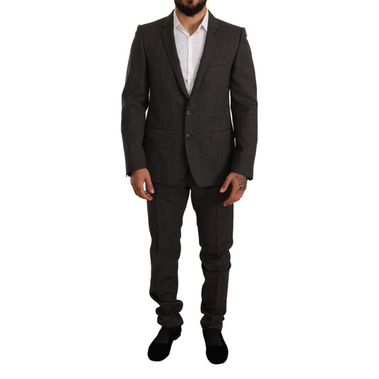 This Pant Suit by Dolce & Gabbana for men in virgin wool black, gray & patterned presents a discerning silhouette, featuring a sophisticated single-breasted neckline and a discerning slim for a refined and polished look.