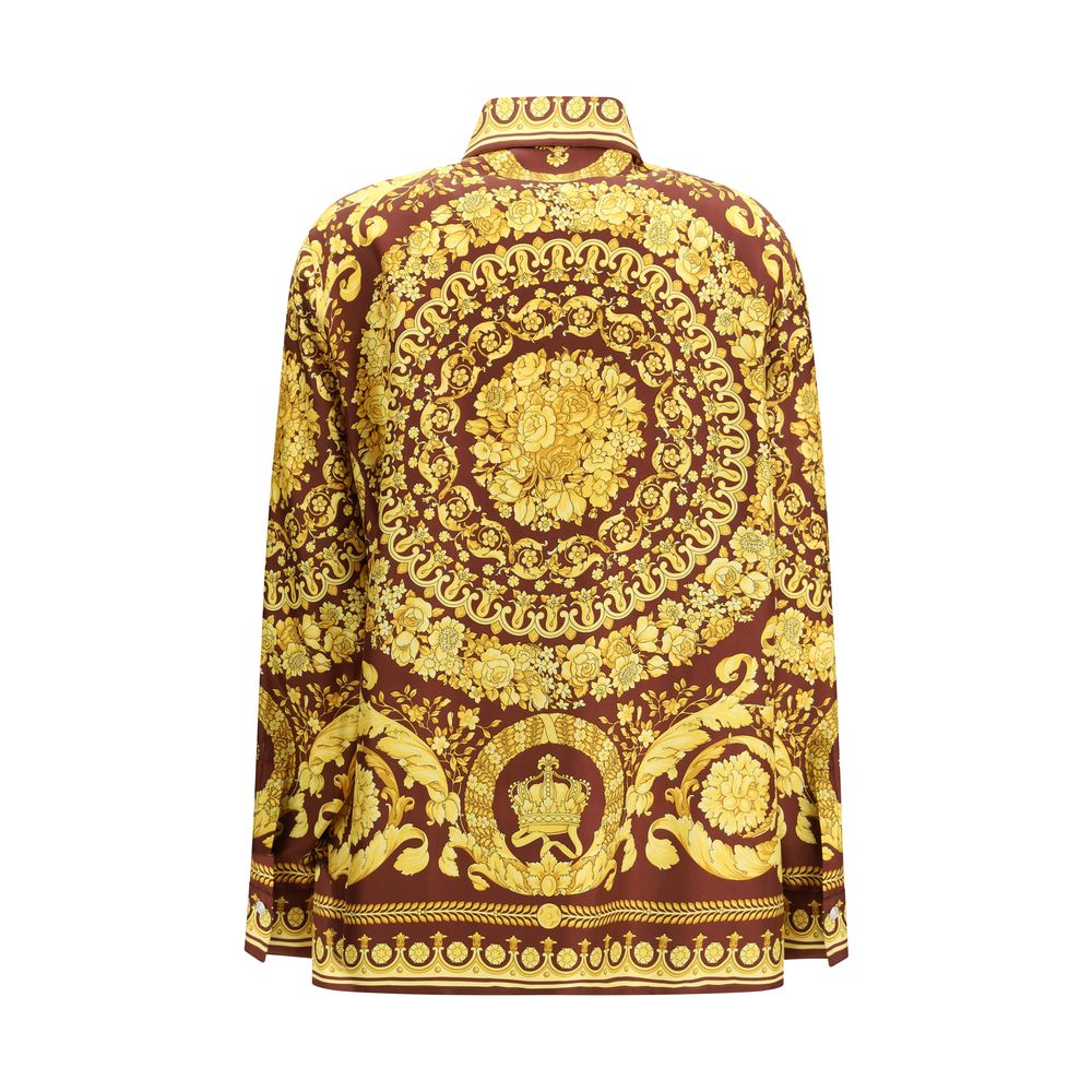 Shirt by Versace for women in silk bordeaux, patterned & print showcases a sharp silhouette, elegantly detailed with a sharp point-collar neckline and sharp .